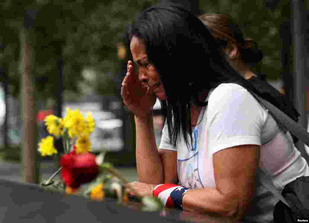 A woman reacts during a ceremony marking the 21st anniversary of the September 11, 2001 attacks on the World Trade Center at the 9/11 Memorial and Museum in the Manhattan borough of New York City, Sept. 11, 2022.