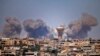 Smoke rises above rebel-held areas of the city of Daraa during reported airstrikes by Syrian regime forces, July 5, 2018.