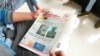 FILE - A man reads a newspaper with the pictures of Amhara state President Ambachew Mekonnen, killed in Bahir Dar, and of Army Chief of Staff Seare Mekonnen, who was shot by his bodyguard, on a street in Addis Ababa, Ethiopia, June 24, 2019.