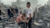 FILE - Palestinians look for survivors following an Israeli airstrike in Nusseirat refugee camp, Gaza Strip, Oct. 31, 2023. Aid for 2.7 million people in Gaza and the West Bank will cost $1.2 billion, a U.N. humanitarian office spokesman said November 3.