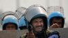 Rapid Action Force personnel guard a major highway at Singhu near New Delhi to stop thousands of protesting farmers from entering the capital, India, Feb.13, 2024.
