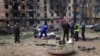 FILE - Police investigators inspect a body near an apartment complex hit in a Russian missile strike in Kryvyi Rih, Ukraine, June 13, 2023. 