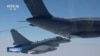 In this image taken from video footage run Saturday, April 8, 2023 by China's CCTV, a Chinese fighter jet performs an mid-air refueling maneuver at an unspecified location. 