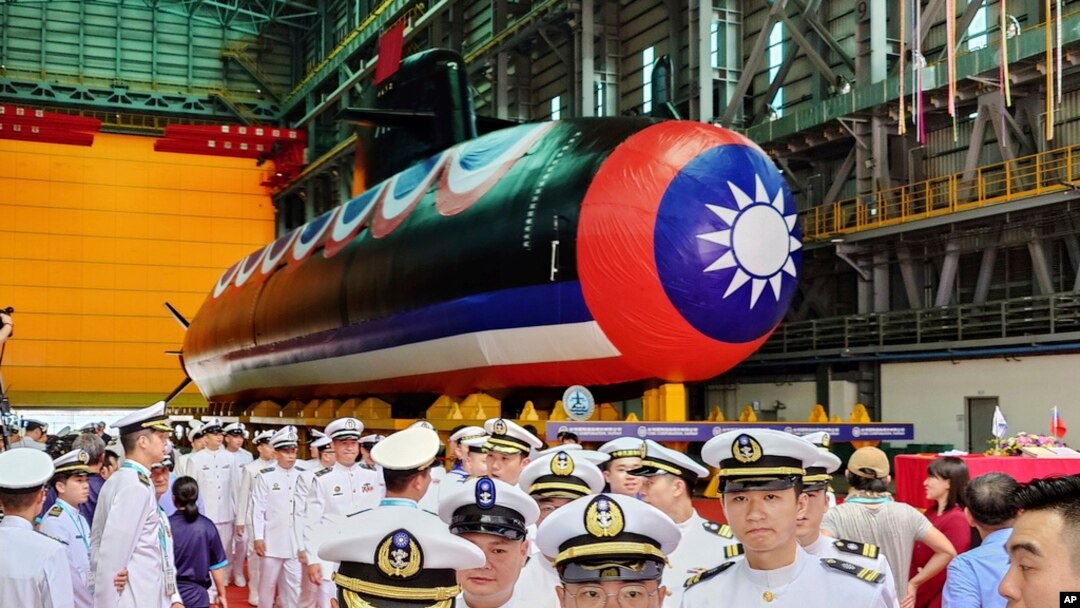 Navy personnel are pictured with Taiwan's first domestically made submarine during the launching ceremony at CSBC Corp.'s shipyards in Kaohsiung, Taiwan, Sept. 28, 2023.