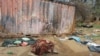 FILE - A picture taken June 16, 2023, shows covered bodies strewn near houses in the West Darfur capital El Geneina, amid ongoing fighting in war-torn Sudan.