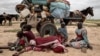 Sudanese family who fled the conflict in Murnei in Sudan's Darfur region, sit beside their belongings while waiting to be registered by UNHCR upon crossing the border between Sudan and Chad in Adre, Chad, July 26 , 2023.