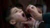 FILE - A health worker gives a polio vaccine to a child in Peshawar, Pakistan, June 27, 2022. 