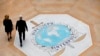 FILE - People walk past the Interpol logo at the international police agency headquarters in Lyon, central France, Nov. 8, 2018.