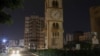 A car drives near a clock tower in Jdeideh, Lebanon, March 25, 2023. 