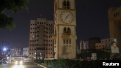 A car drives near a clock tower in Jdeideh, Lebanon, March 25, 2023. 
