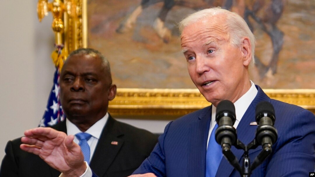 U.S. President Joe Biden delivers remarks on recovery efforts for the Maui wildfires and the response to Hurricane Idalia in the Roosevelt Room of the White House in Washington, Aug. 30, 2023. Secretary of Defense Lloyd Austin, left, stands behind him.