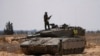 Israeli soldiers are seen near the border with the Gaza Strip, in southern Israel, May 7, 2024.
