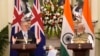 Indian Prime Minister Narendra Modi watches as his Australian counterpart Anthony Albanese makes a press statement, in New Delhi, India, Friday, March 10, 2023.