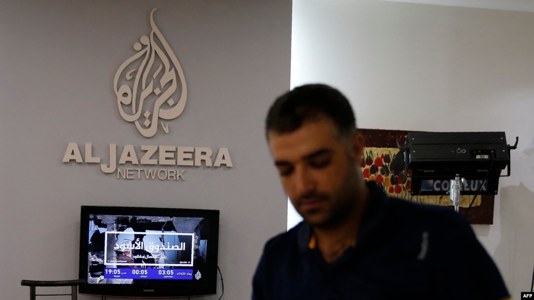 FILE - An employee of Qatar-based news channel Al Jazeera is seen at the media outlet's offices in Jerusalem, July 31, 2017.