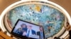 UN High Commissioner for Human Rights Volker Türk is seen on a TV monitor as the ceiling of the Human Rights and Alliance of Civilizations Room is seen in the background at the opening of the 53rd UN Human Rights Council in Geneva, June 19, 2023.