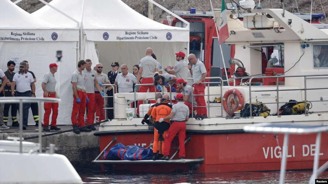 Rescue personnel work next to the body bag containing the corpse of British entrepreneur Mike Lynch, who died when a yacht owned by his family sank off the coast of Porticello, near the Sicilian city of Palermo, Italy, Aug. 22, 2024. 