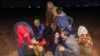 People react in the aftermath of Syrian government forces' bombardment at a camp for those displaced by conflict in Sarmin in the rebel-held part of Syria's northwestern Idlib province, Sept. 23, 2023. 