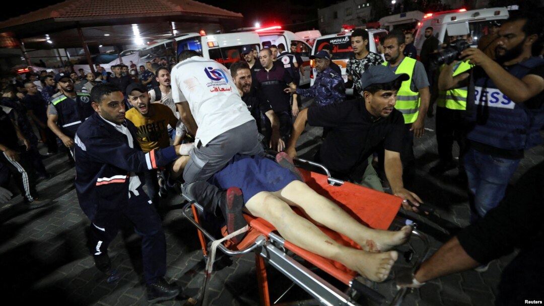 An injured person is assisted at Shifa Hospital after an Israeli air strike hit the nearby Al-Ahli Hospital, according to Gaza Health Ministry, in Gaza City, Gaza Strip, Oct. 17, 2023.