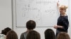 FILE - Olha Kovalevska, a teacher of Ukrainian literature at a school run by the Unbreakable Ukraine foundation in Warsaw, Poland, instructs refugee students on June 3, 2023.