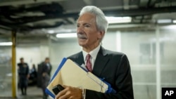 FILE - Newspaper founder and editor Jose Ruben Zamora leaves in handcuffs after a court hearing in Guatemala City, June 14, 2023. A court on May 15, 2024, granted him a conditional release from jail.