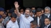 Rahul Gandhi, a senior leader of India's main opposition Congress party, waves as he leaves a court after he lodged an appeal against his conviction for defamation, in Surat in the western state of Gujarat, India, April 3, 2023. 