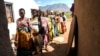 FILE - Pregnant women queue to see Lucy Mbewe, a traditional birth attendant, at her home in Simika Village, Chiradzulu, southern Malawi, May 23, 2021. Health officials say fewer women are getting prenatal care amid the COVID-19 pandemic. 