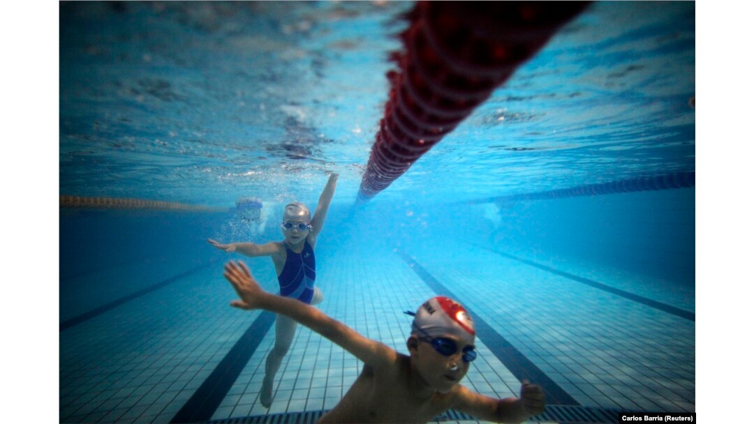 FILE - Kids swim in the deep end at Hangzhou Chen Jinglun Sports School Natatorium in Hangzhou, China, August 2, 2012. (REUTERS/Carlos Barria)