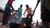 FILE - People prepare food in a Khartoum, Sudan, neighborhood on June 16, 2023. Over 42% of the population of the beleaguered country faces acute hunger, U.N. agencies said on Aug. 11, 2023.