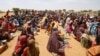 Sudanese refugees, who fled the violence in their country, wait to receive food assistance at a camp near the Sudan-Chad border, in Koufroun, Chad, May 9, 2023. 