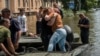 Local residents react after evacuation from a flooded area after the Kakhovka dam breached, in Kherson, Ukraine, June 9, 2023. 