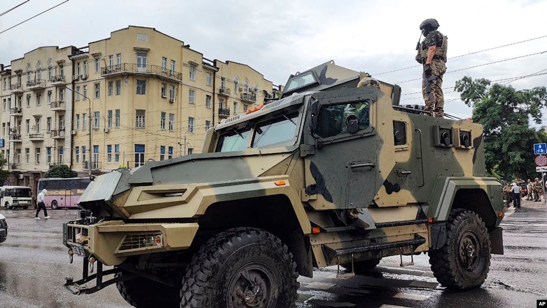 A serviceman stands atop an armored vehicle of the Wagner Group military company, guarding an area at the HQ of the Southern Military District, Rostov-on-Don, Russia, June 24, 2023.