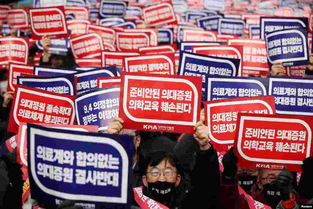 Doctors chant slogans during a rally to protest against government plans to increase medical school admissions in Seoul, South Korea.