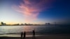 FILE - People walk along a beach at Vilimalé island in the the Maldives on Nov. 15, 2023. The Maldives is in hot water over calls to boycott the tropical destination, following derogatory remarks about Prime Minister Narendra Modi by government ministers.