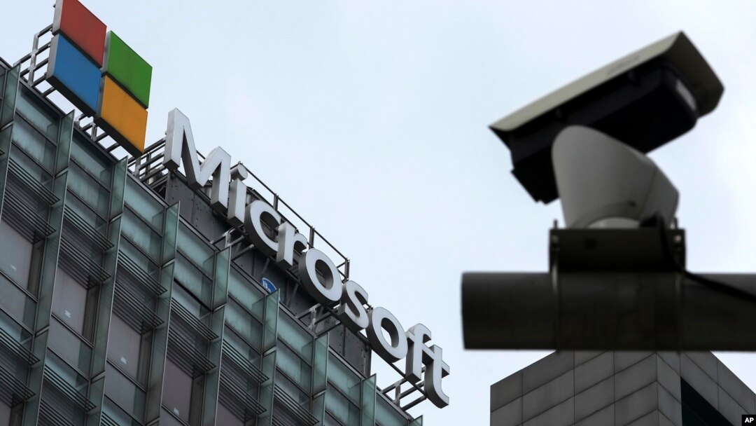 FILE - A security surveillance camera is seen near the Microsoft office building in Beijing, China, July 20, 2021.