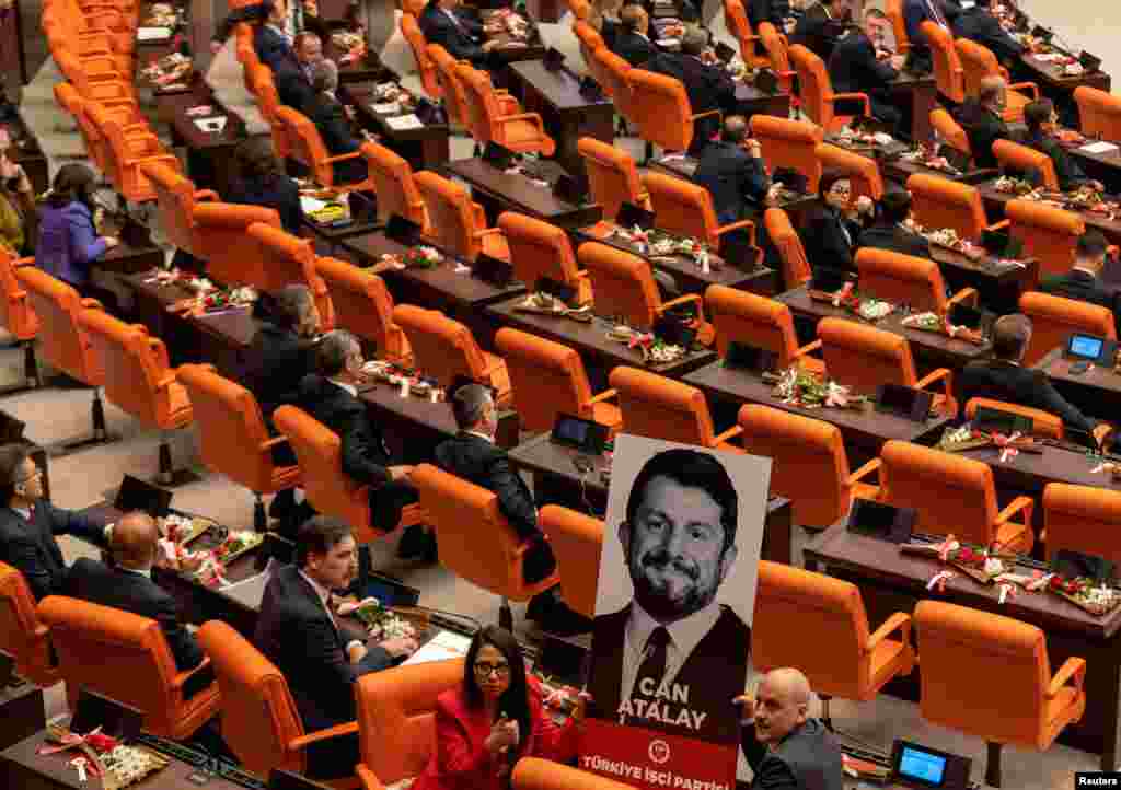 Erkan Bas, the leader of Workers&#39; Party of Turkey (TIP), and his party MPs Sera Kadigil and Ahmet Sik display a portrait of Can Atalay, a jailed MP of TIP, during a swearing-in ceremony at the Turkish parliament in Ankara, Turkey.&nbsp;Atalay has not been released despite a law that opens a way for jailed politicians to be released from prison if they are elected to parliament.