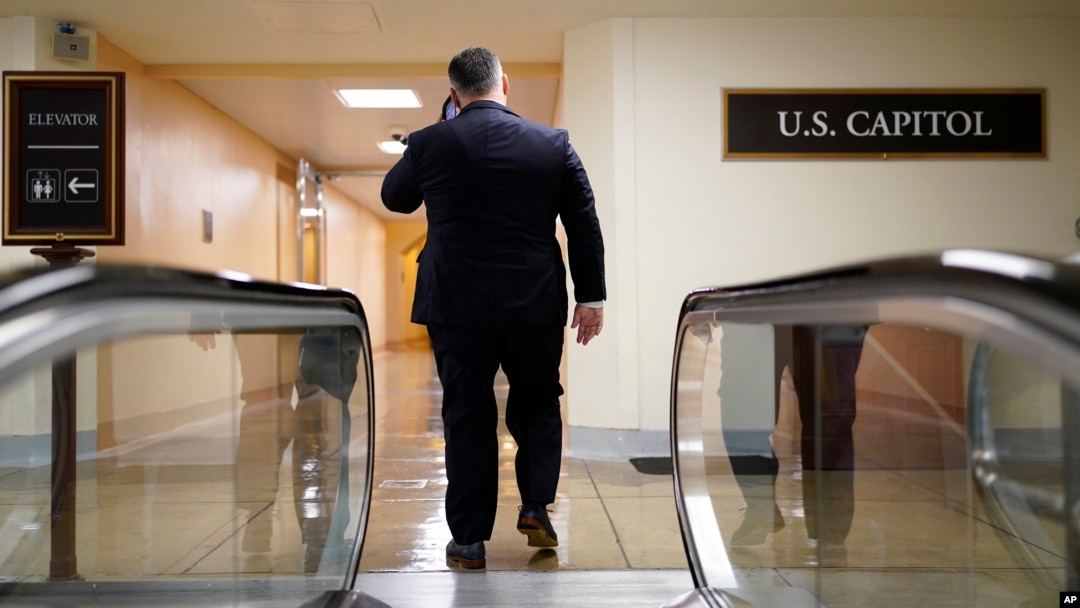 FILE - A man speaks on his phone at the Capitol in Washington, June 22, 2022. Lobbying firms in Washington reportedly are dropping clients from China amid growing concerns about Beijing’s influence on Capitol Hill.