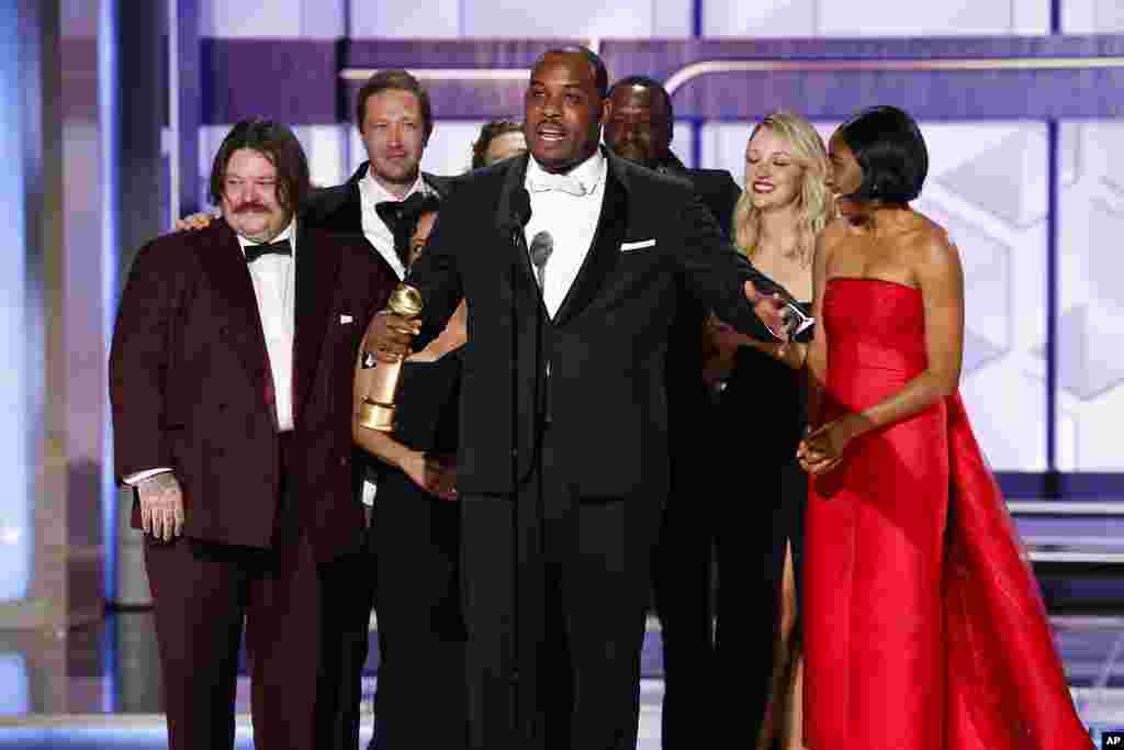 This image released by CBS shows Lionel Boyce, center, with the cast of "The Bear" as they accept the award for best television series - musical or comedy during the 81st Annual Golden Globe Awards in Beverly Hills, Calif., on Sunday, Jan. 7, 2024. 