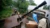 An armed pro-Russian separatist from the so-called Vostok (East) Battalion stands guard at a checkpoint in the eastern Ukrainian city of Donetsk July 8, 2014.