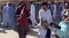 FILE - This screenshot of a video sent to VOA Persian appears to show residents of Zahedan, Iran, carrying a man with bloodstained clothing, Sept. 30, 2022. Human rights groups said 66 civilians were slain and scores were injured inside and outside a mosque in the city. (UGC)