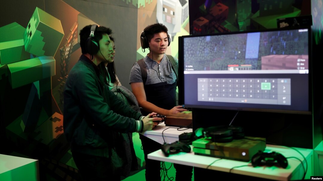 FILE - Gamers play Minecraft at the Paris Games Week (PGW), a trade fair for video games in Paris, France.