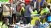 The Electoral Commission (IEBC) Chairman, Wafula Chebukati, middle in red shirt, and IEBC commissioners at the National Tallying Centre in Bomas of Kenya, Nairobi, Kenya, Aug. 14, 2022.