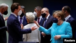 Germany's Chancellor Angela Merkel, right, talks to Austrian Chancellor Sebastian Kurz during an EU summit at the European Council building in Brussels, Belgium, June 24, 2021. 