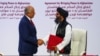 Mullah Abdul Ghani Baradar, Taliban delegation leader, and Zalmay Khalilzad, U.S. envoy for peace in Afghanistan, shake hands after signing an agreement between members of Afghanistan's Taliban and the U.S. in Doha, Qatar, Feb. 29, 2020.