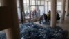 FILE - Local residents receive drinking water at a distribution centre in Toretsk, eastern Ukraine, April 25, 2022. 