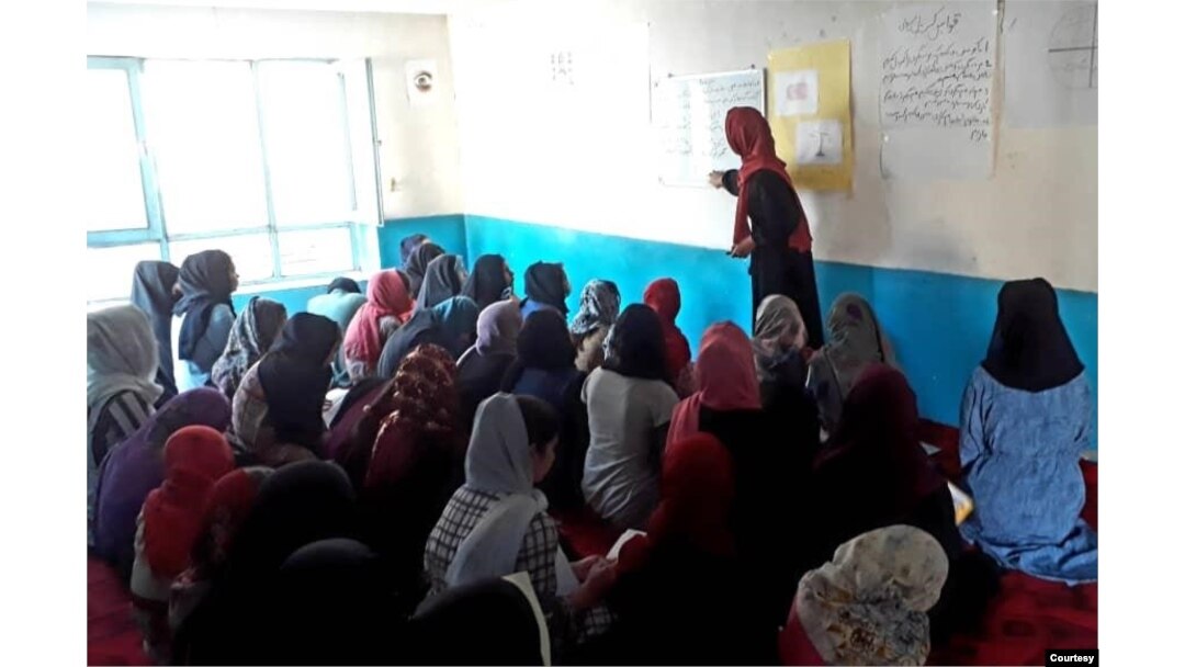 FILE - Girls barred from education by Taliban study in a secret school run by volunteers in Afghanistan in this undated photo. (Photo courtesy Parasto)