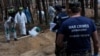FILE - A war crimes prosecutor looks on as experts work at a forest grave site during an exhumation in the town of Izium, in Ukraine's Kharkiv region, Sept. 18, 2022, after Ukrainian forces pushed invading Russian troops out of the area.