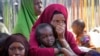 FILE - Somalis who fled drought-stricken areas of their country sit at a makeshift camp on the outskirts of the capital, Mogadishu, Feb. 4, 2022. Thousands of desperate families have fled a severe drought across large parts of Somalia.