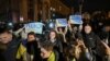 People hold a slogan which reads "11/11/2022 - Kherson - Ukraine" as they gather in Maidan square to celebrate the liberation of Kherson, in Kyiv on November 11, 2022, amid the Russian invasion of Ukraine. - Ukraine's President Volodymyr Zelensky said on 