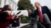 FILE - CNN journalist Abby Phillip asks President Donald Trump a question as he speaks with reporters before departing for France on the South Lawn of the White House.