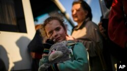 Una niña y su familia que huyeron de Mariúpol llegan a un centro de recepción para personas desplazadas en Zaporizhzhia, Ucrania, el 8 de mayo de 2022.